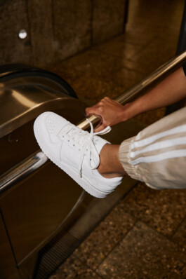 Close up of a young woman in Adidas attire shot in the subway of Munich, fashion editorial for About You by Philipp Messer 