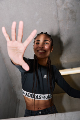 Photo of a young woman in Adidas attire shot in the subway of Munich, fashion editorial for About You by Philipp Messer 